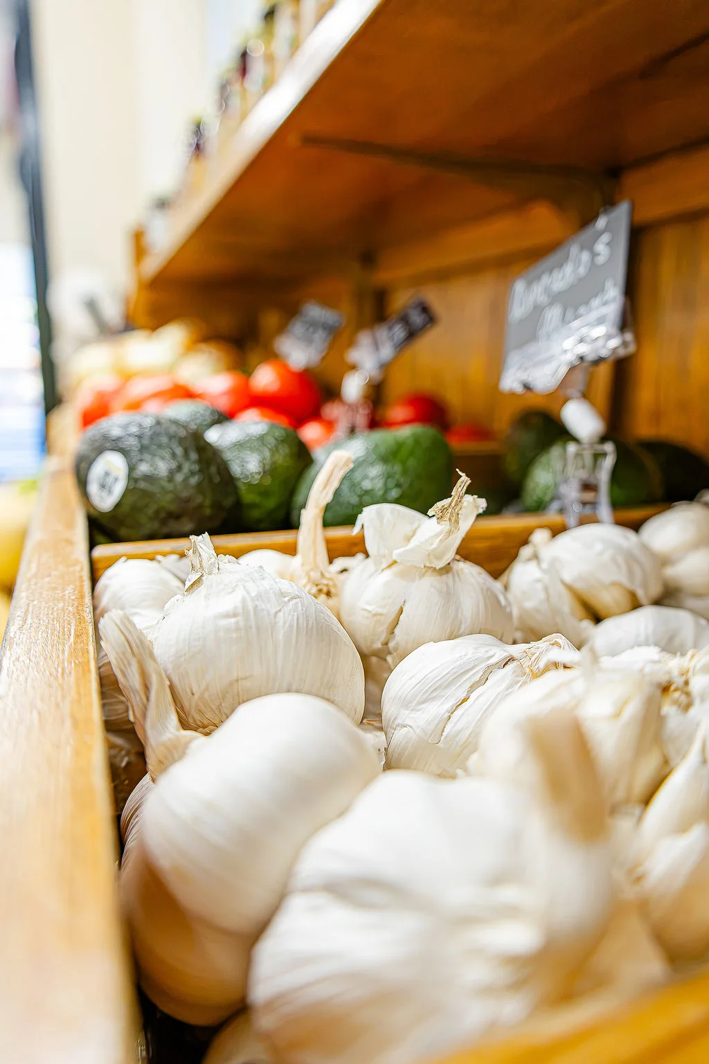Garlic and avocados in the market produce display