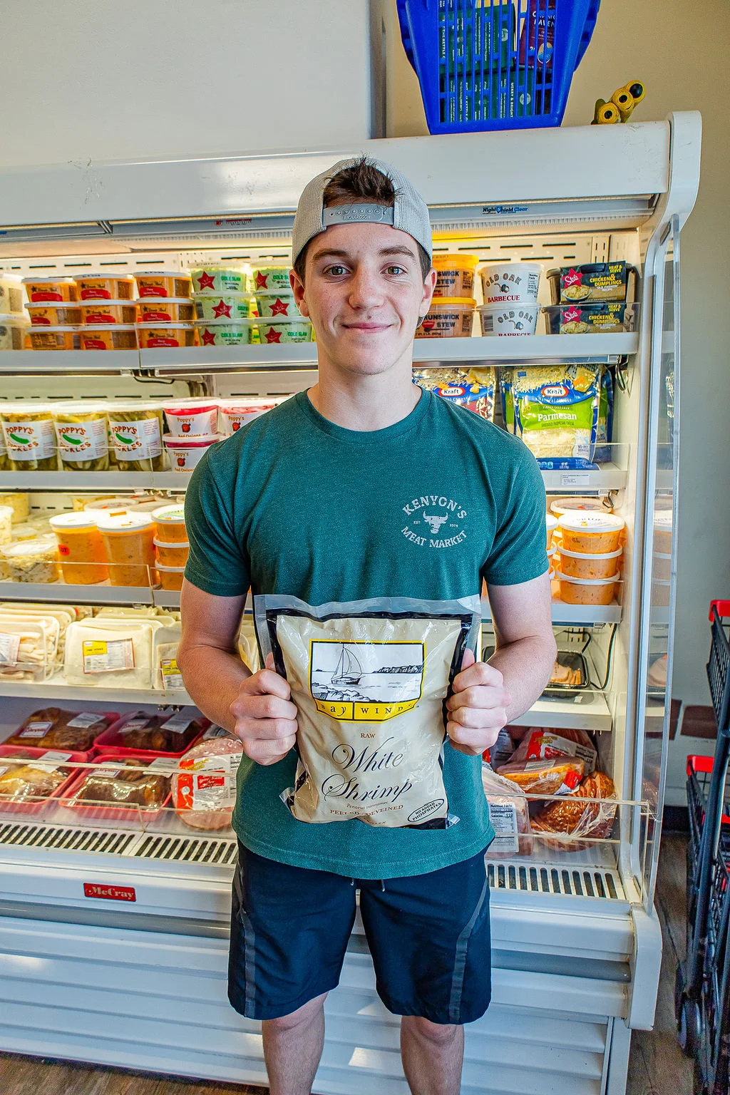Kenyon’s crew member holding a package of frozen shrimp